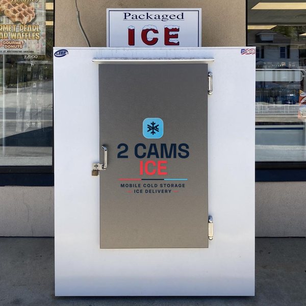 Outdoor bagged-ice merchandiser with the 2 Cams Ice logo on the door, stocked with ice bags