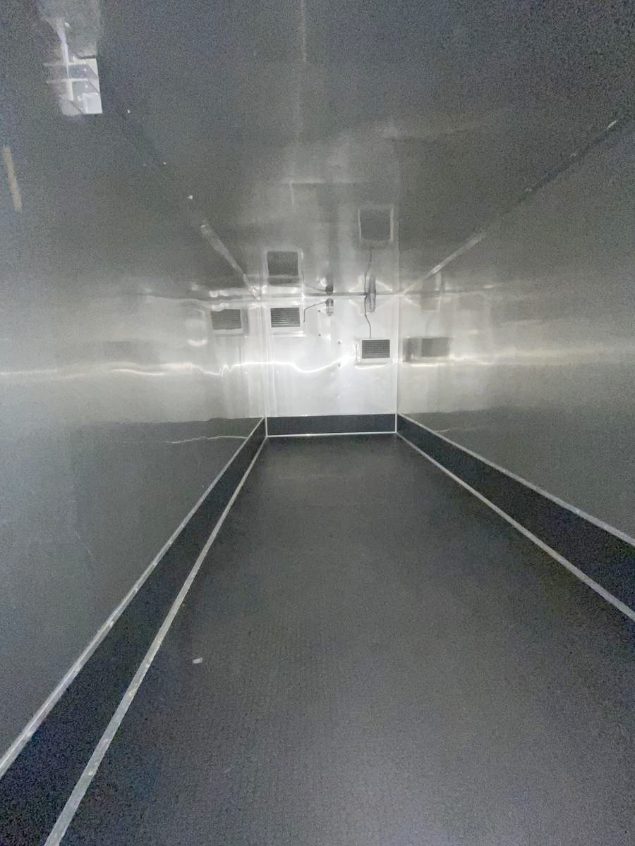 Inside an empty 2 Cams Ice refrigerated trailer rental, showing the full interior space